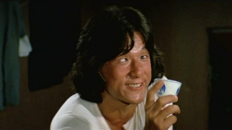 drunken master drunk jackie chan holds cup and crosses eyes