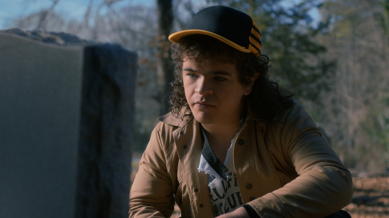 Dustin looking at Eddie's grave in Stranger Things