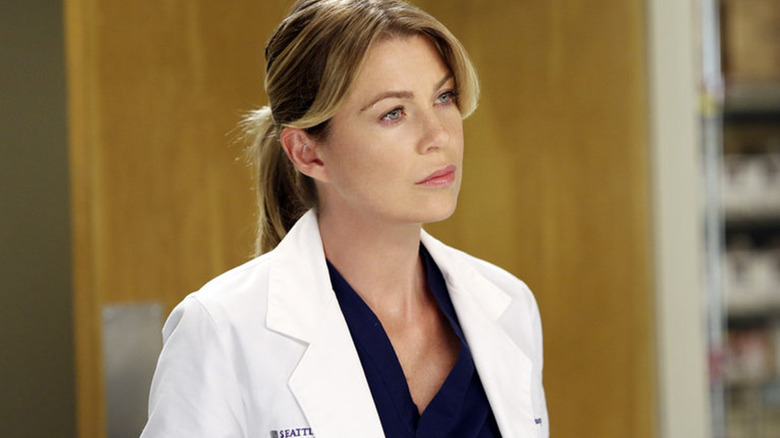 Meredith standing in front of a door on Grey's Anatomy