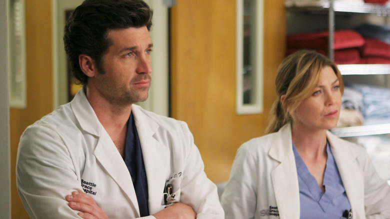Derek standing next to Meredith on Grey's Anatomy