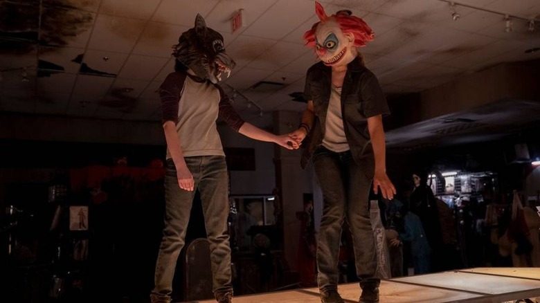Ellie and Riley wearing Halloween masks in The Last of Us