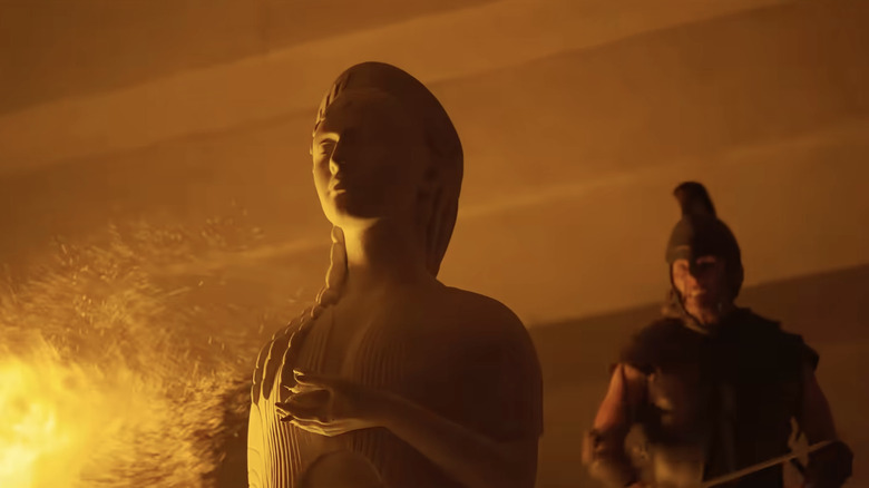 A Greek soldier preparing to chop the head off a statue of Athena in The Odyssey (2026)