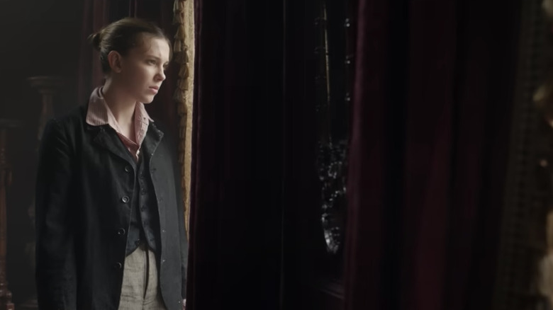 Enola Holmes 2 Millie Bobby Brown looking out window