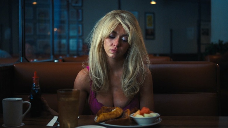 Sydney Sweeney as Cassie sadly looking at her food at a diner in Euphoria Season 3