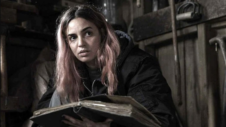 Alice settles in for some light reading in Evil Dead Burn