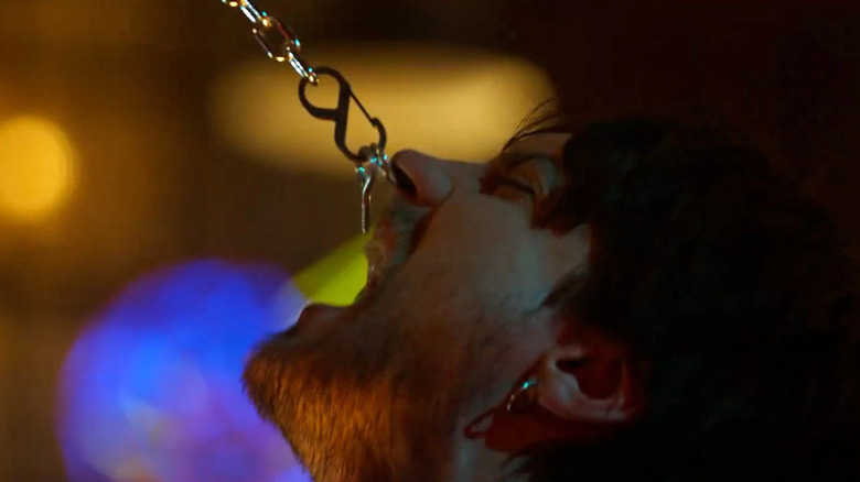 Erik with his septum ring stuck to a chain in Final Destination Bloodlines