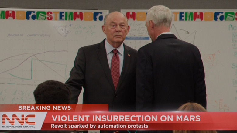 Randy Oglesby as President James Bragg receiving bad news from an aide while standing in a children's classroom in For All Mankind