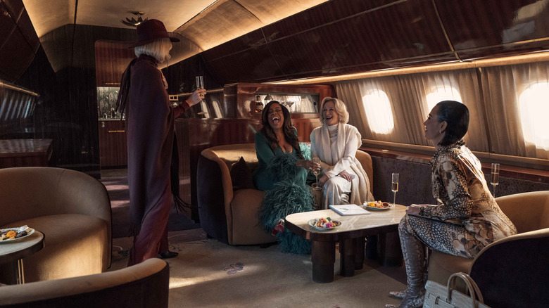 Liberty, Emerald, Dina, and Allura on a private plane drinking champagne and laughing in All's Fair