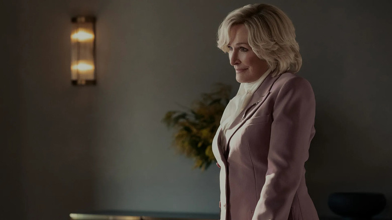 Dina smiling at someone in an office on All's Fair