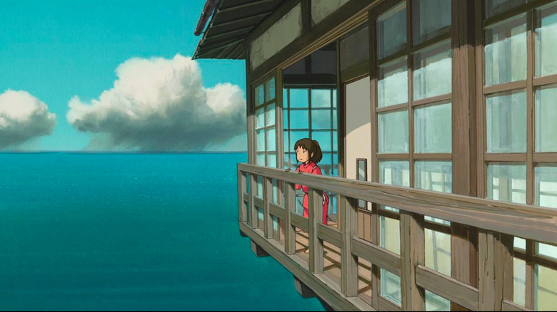 Chihiro Stands On a Bathhouse Balcony Looking Out at the Water