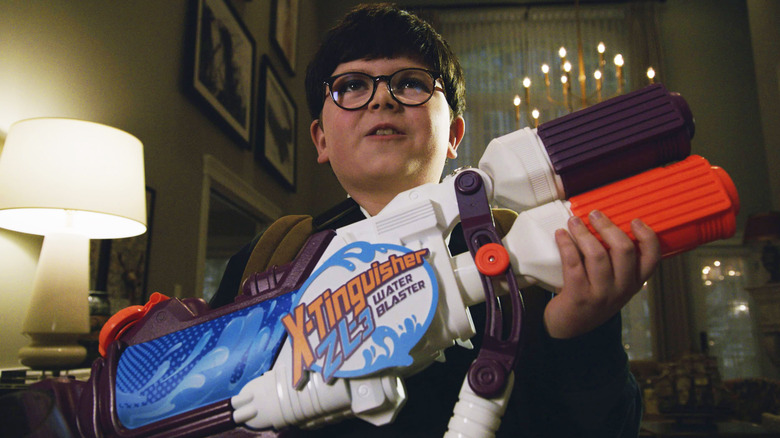 Archie Yates as Max with his X-Tiinguisher water blaster in Home Sweet Home Alone