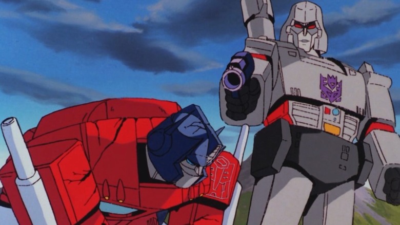 Megatron standing over and about to shoot a wounded Optimus Prime with his laser pistol in The Transformers: The Movie