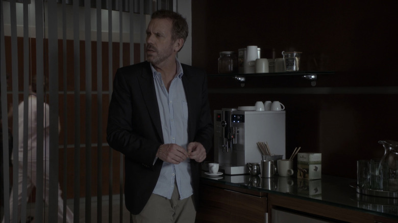 Hugh Lori as a house makes a coffee in his office in the house