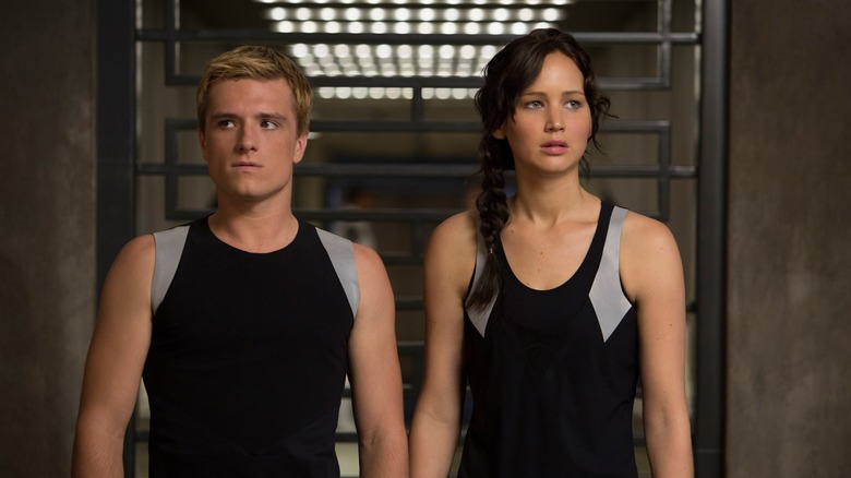 Josh Hutcherson as Peeta and Jennifer Lawrence as Katniss walking into the training room in The Hunger Games: Catching Fire