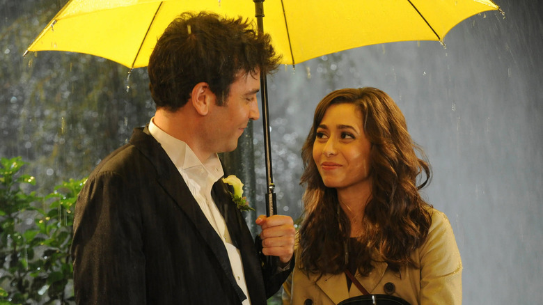 Ted and Tracy smiling under the yellow umbrella on How I Met Your Mother