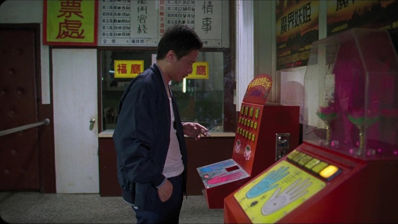 A man playing an arcade game in Goodbye, Dragon Inn