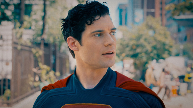 Superman looking left with a smile while walking down the street in 2025's Superman