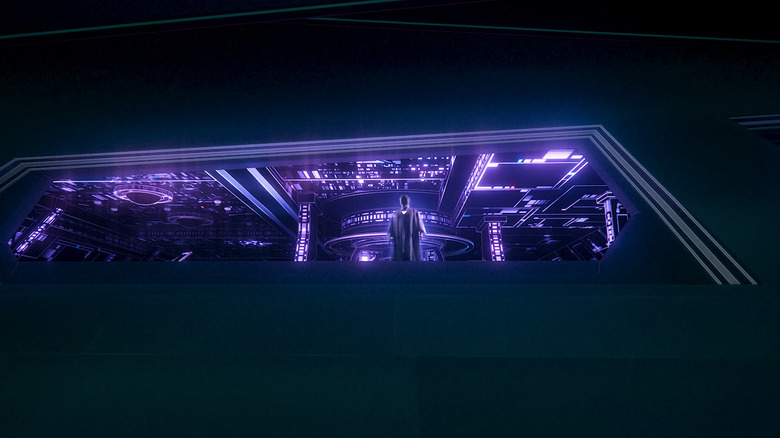 Jeff Bridges' Kevin Flynn stands looking down from a large window in Tron Ares