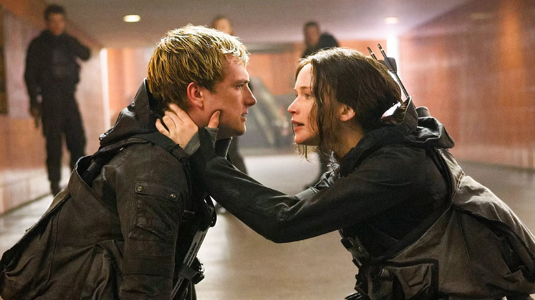 Katniss holding a traumatized Peeta in The Hunger Games: Mockingjay - Part 2