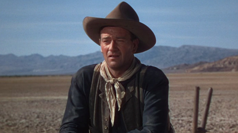 John Wayne gazes from a ranch fence in 3 Godfathers