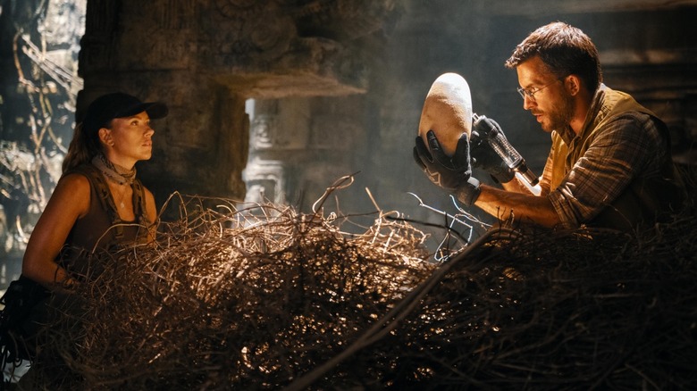 Scarlett Johansson as Zora Bennett and Jonathan Bailey as Dr. Henry Loomis taking a Quetzalcoatlus egg