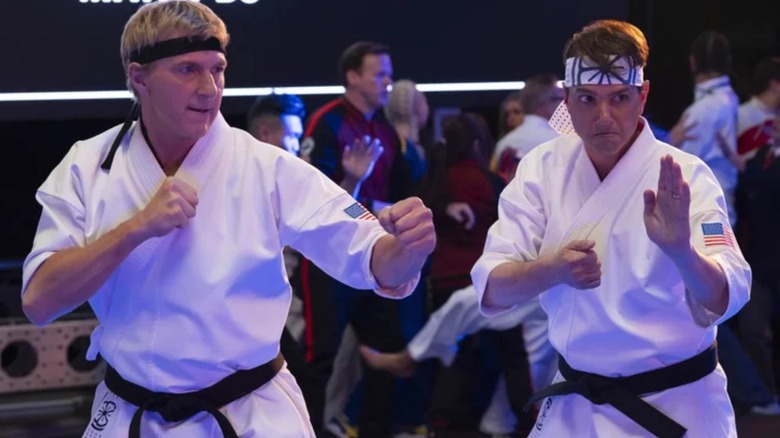 Johnny Lawrence and Daniel LaRusso in their karate gis ready to fight