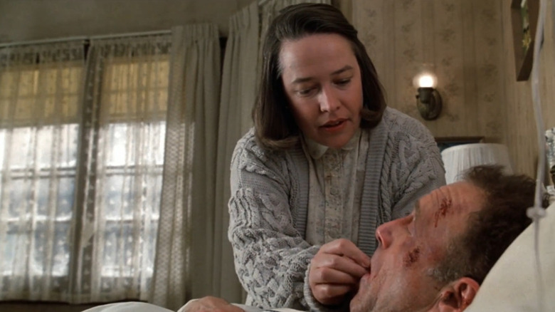 Misery, Annie putting pills in Paul's mouth
