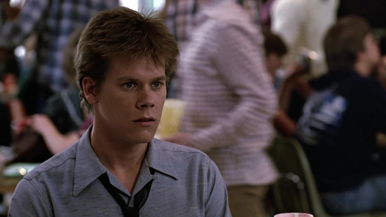 Ren McCormack sitting in a school cafeteria in Footloose (1984)