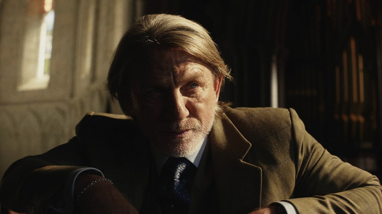 Benoit Blanc, with half his face in shadow and half in sunlight, in Wake Up Dead Man