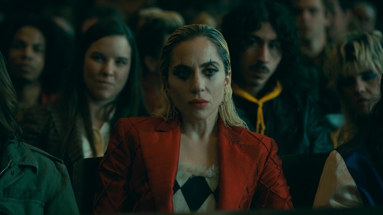 Harley in clown makeup in a courtroom in Joker: Folie à Deux