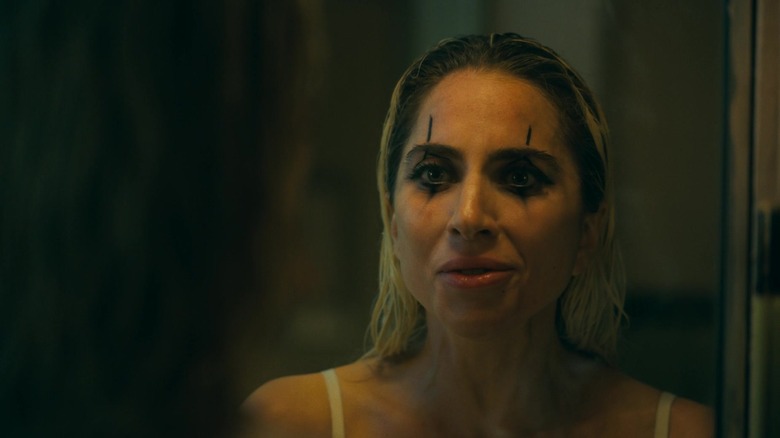 Harley putting on clown makeup in Joker: Folie à Deux