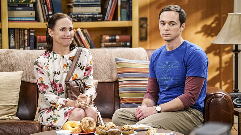 Mary grimacing next to Sheldon on the couch on The Big Bang Theory