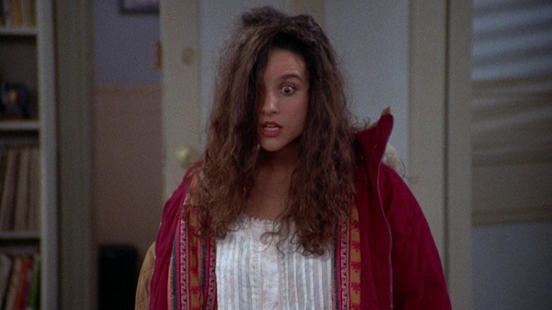 Elaine Benes, her hair a mess, looking astonished at something in an episode of Seinfeld.
