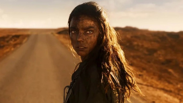 Anya Taylor-Joy as Furiosa looking over her shoulder in Furiosa: A Mad Max Saga