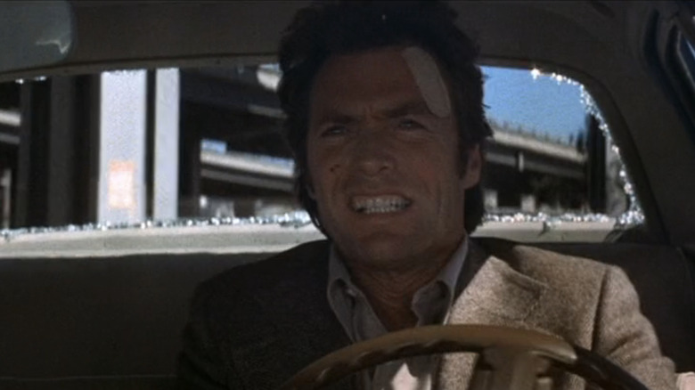 Clint Eastwood as Harry Calahan grits his teeth as he drives a car in Magnum Force