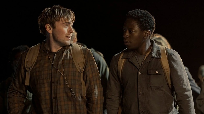 Cooper Hoffman as Raymond Garraty and David Jonsson as Peter McVries walking at night in The Long Walk