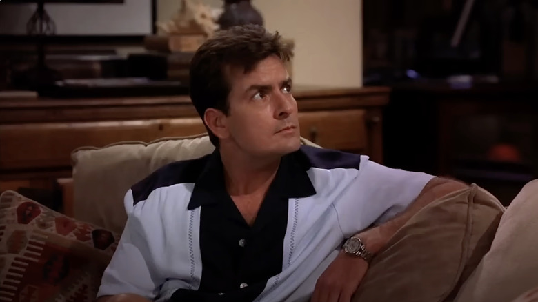 Charlie sitting on a couch listening in Two and a Half Men