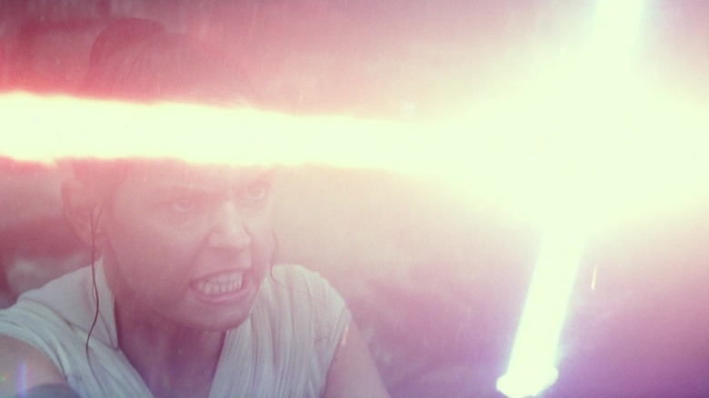 Rey grimacing during a lightsaber battle in Star Wars: The Rise of Skywalker