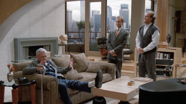 Kelsey Grammer's Frasier Crane and David Hyde Pierce's Niles Crane stand in front of their father John Mahoney's Martin Crane in Frasier's apartment in Frasier