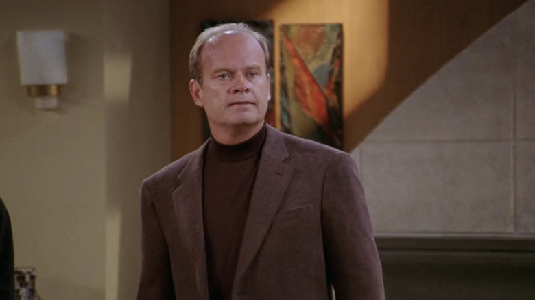 Kelsey Grammer's Frasier Crane stands in his apartment in Frasier