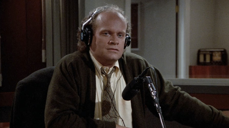 Kelsey Grammer's Frasier Crane sits at his radio studio desk in Frasier