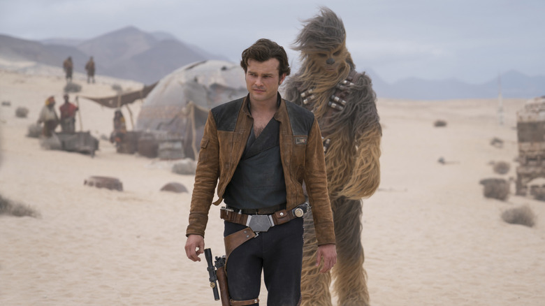 Alden Ehrenreich's Han Solo and Chewbacca walking behind him in Solo: A Star Wars Story