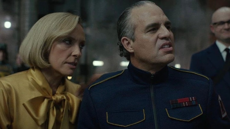 Mark Ruffalo's Kenneth Marshall sneering next to Toni Collette's Ylfa in Mickey 17