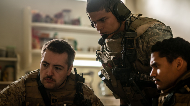 Michael Gandolfini as Macdonald, D'Pharaoh Woon-A-Tai as Ray, and Adain Bradley as Laerrus huddled around a monitor in Warfare