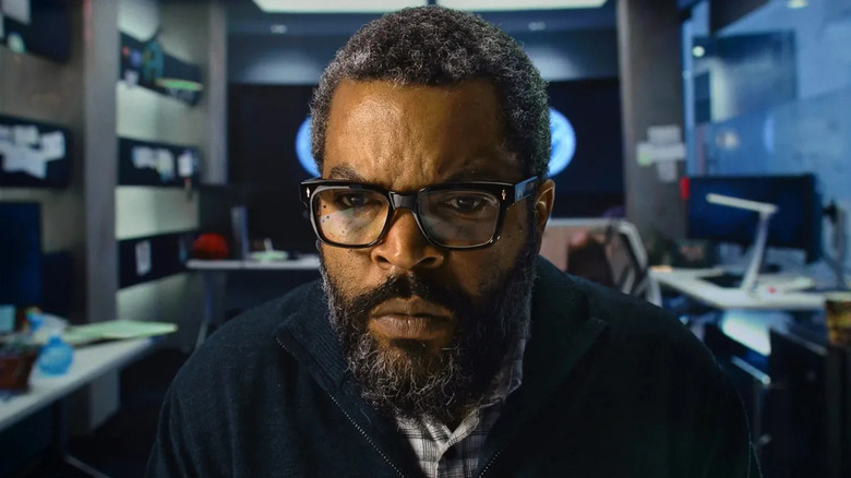 Will Radford looking at a screen in War of the Worlds (2025)
