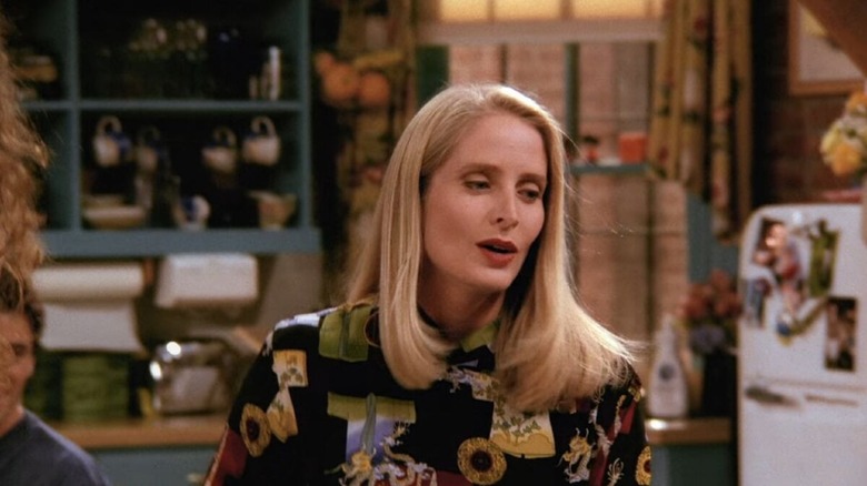 Jane Sibbett as Carol Willick standing near a refrigerator in Friends