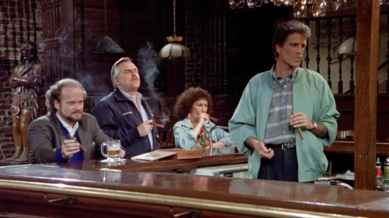 Several characters from Cheers gathered around the bar, smoking cigars.