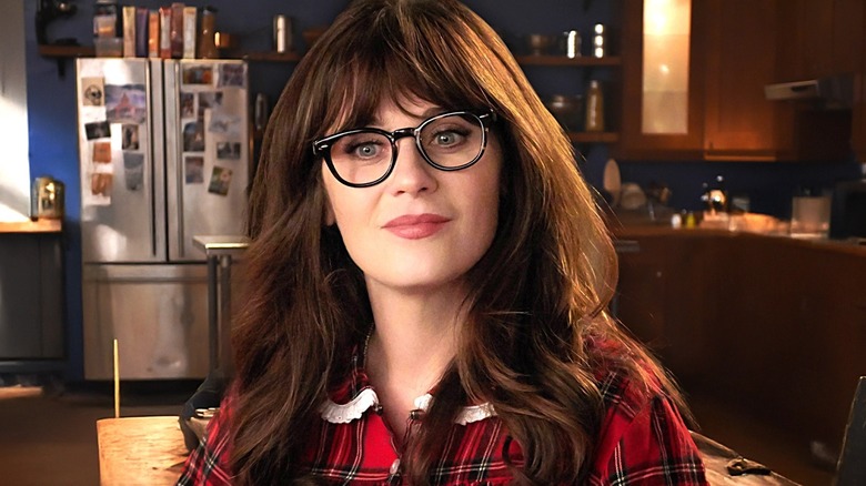 Zooey Deschanel's Jess standing in her apartment in New Girl
