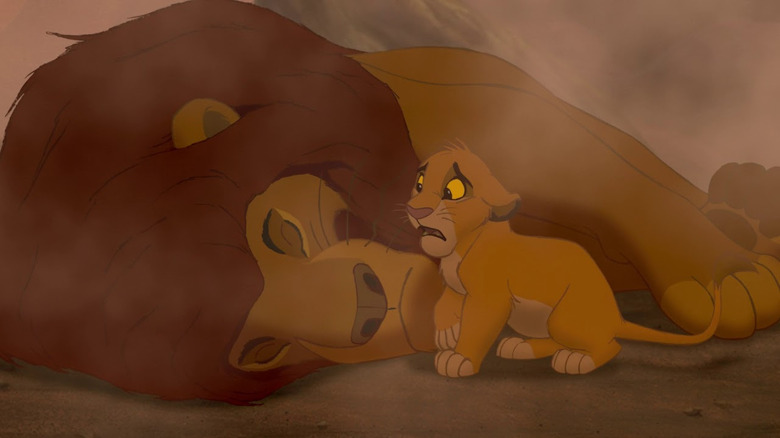 Simba looks sad next to Mufasa's dead body in The Lion King