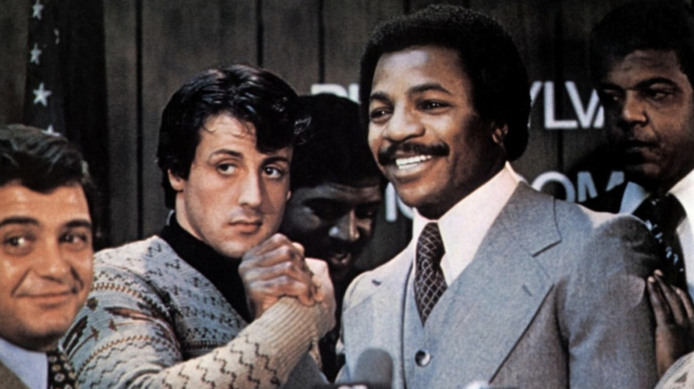 Balboa and Creed are all smiles at a press conference in Rocky